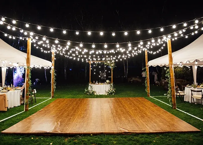 Portable dance floor rental installed under an event tent