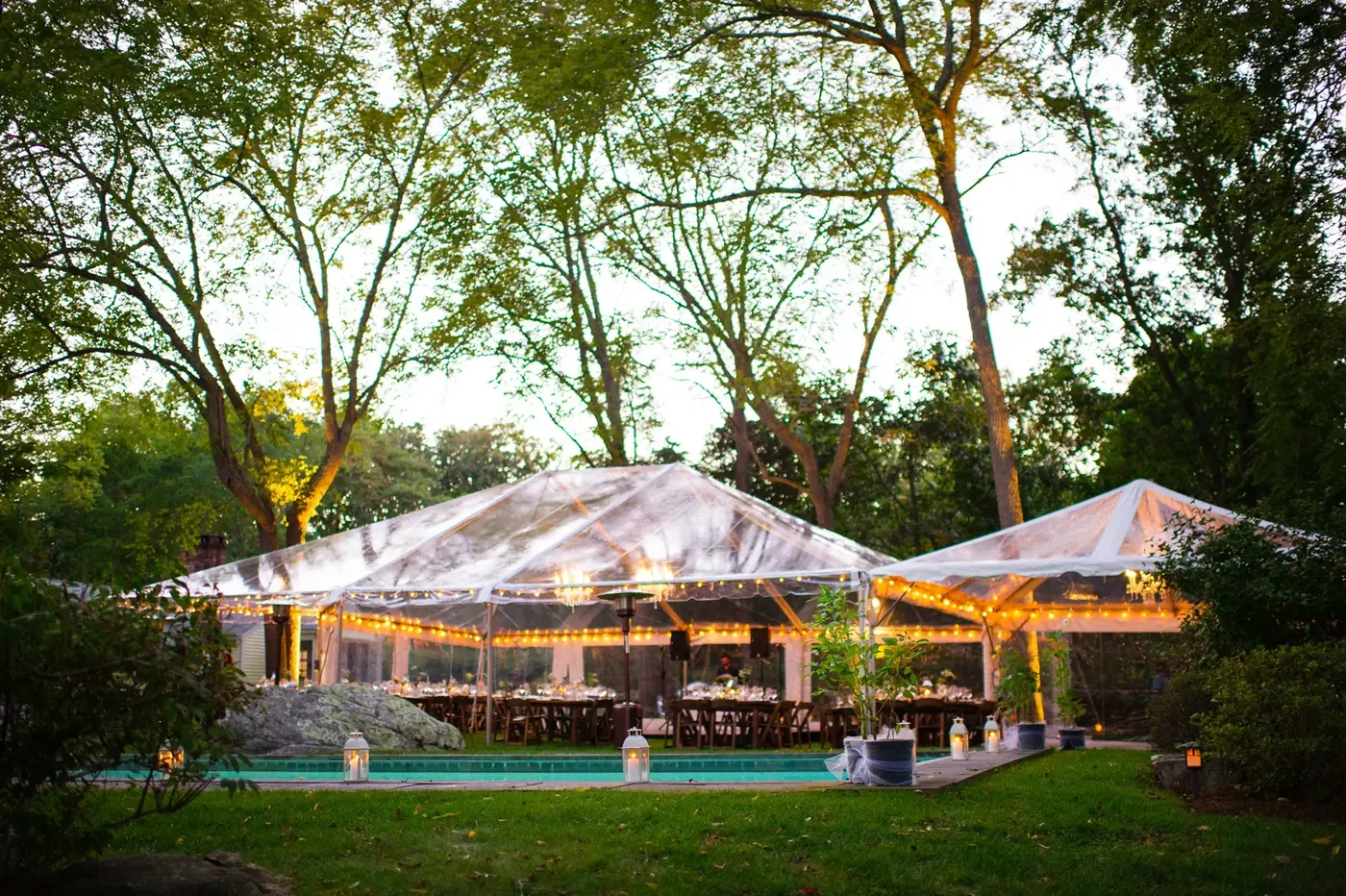 White frame tent installed on a paved surface for an outdoor celebration